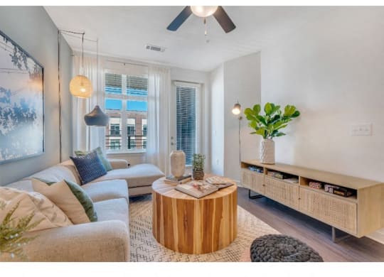 a living room filled with furniture and a large window