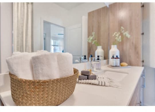 a bathroom with a basket of towels and a sink