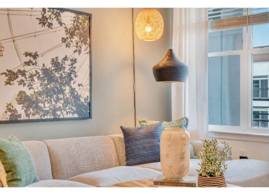 a living room with a couch and a lamp and a window