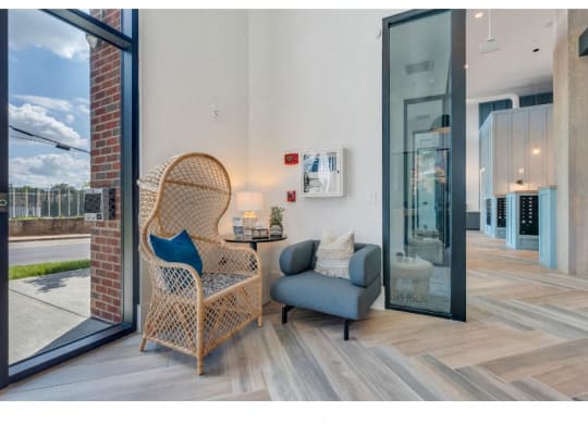 a living room with a chair and a couch next to a glass door
