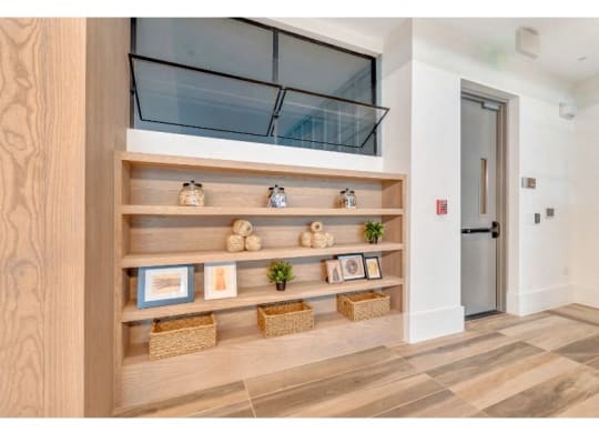a hallway with shelves and a glass door