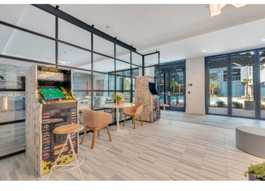 a game room with a foosball table and chairs