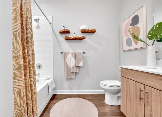 a bathroom with a shower curtain and a toilet and a sink