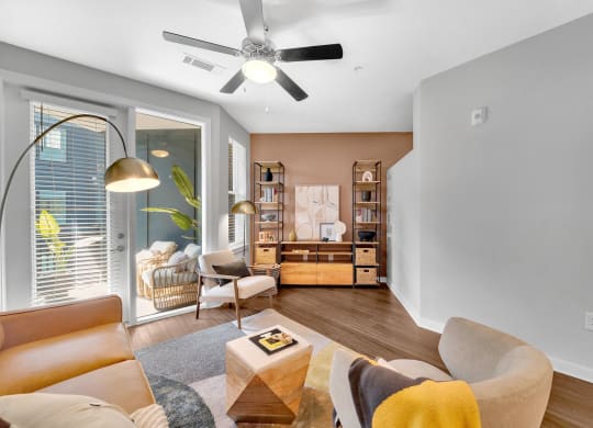 a living room with a couch and a ceiling fan