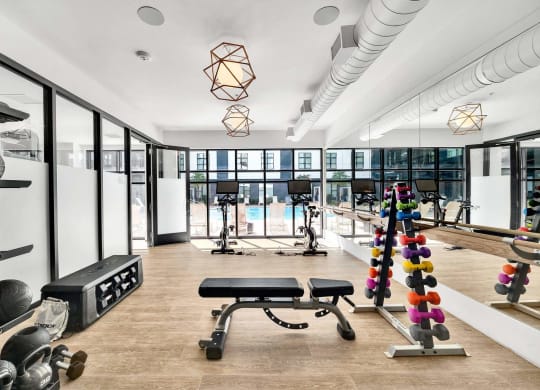 a gym with a pool and a lot of exercise equipment