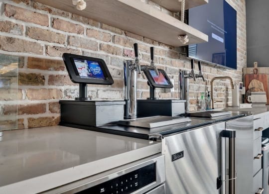 a kitchen with appliances and a brick wall