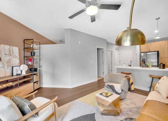a living room with furniture and a ceiling fan
