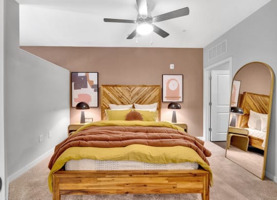 a bedroom with a bed and a ceiling fan