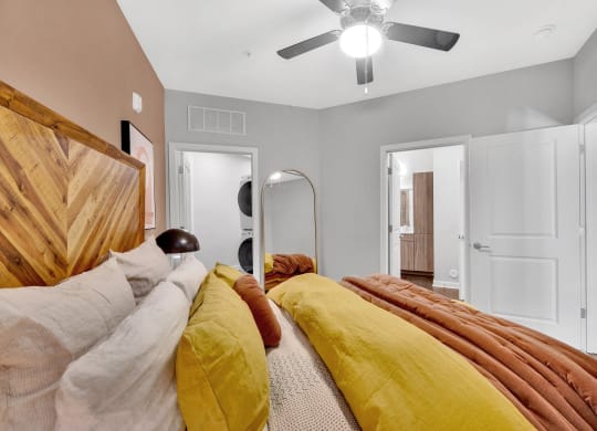 a bedroom with a bed and a ceiling fan