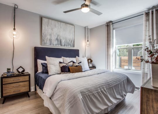 a bedroom with a bed and a ceiling fan