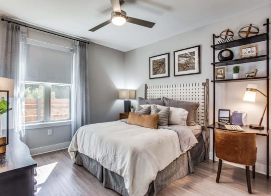 a bedroom with a bed and a ceiling fan