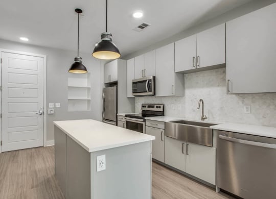 a kitchen with white cabinets and stainless steel appliances