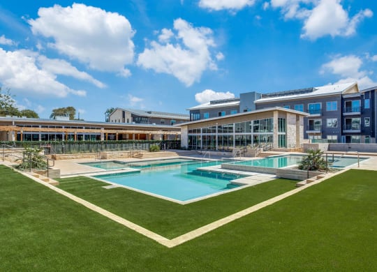 a large pool with a building in the background