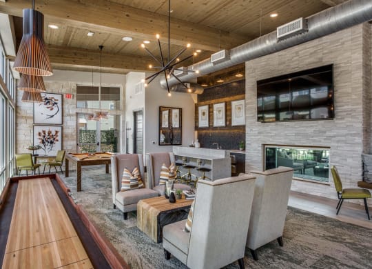 a large living room with a fireplace and chairs