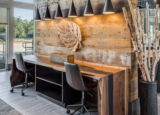 a conference room with a wooden wall and a desk with chairs