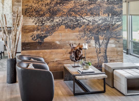 a living room with a tree mural on the wall