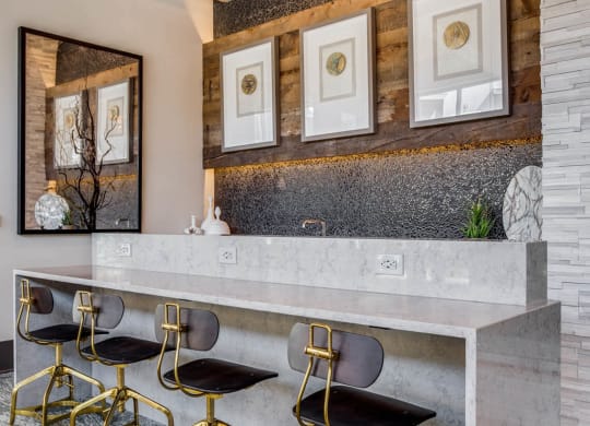 a bar with chairs in a room with a marble counter