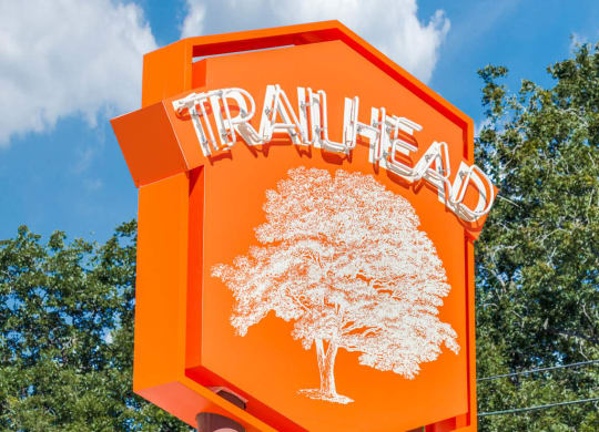 a orange traffic sign with a tree on it