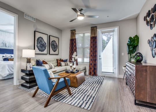 a living room with a couch and a table     and a bedroom