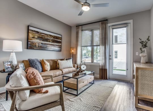 a living room with a couch and a table and a wall with different colored stripes