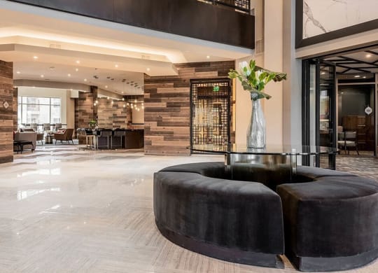 the lobby or reception area of a hotel with black furniture