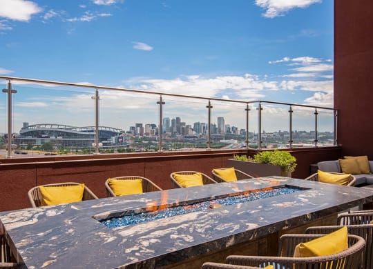 a view of the city from a terrace with a table and chairs