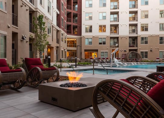 a patio with chairs and a fire pit