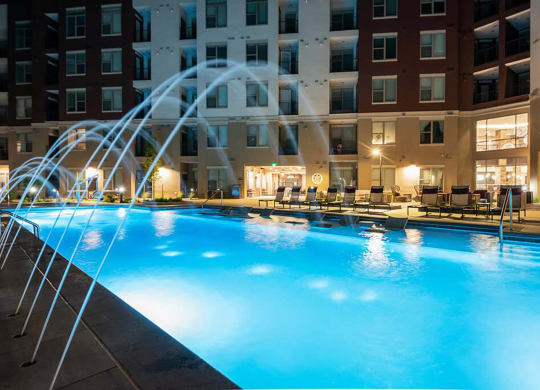 a swimming pool at a hotel with a water fountain