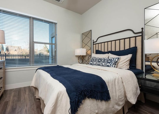 a bedroom with a bed and a large window