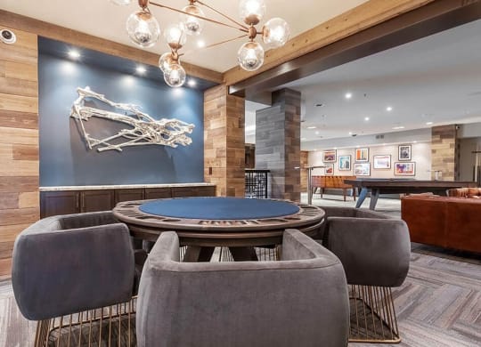 a poker table is in the center of a room with chairs