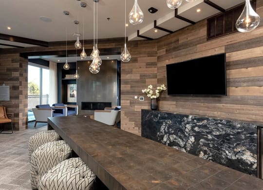 a large living room with a long table and a tv