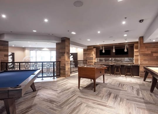 a game room with a pool table and a bar