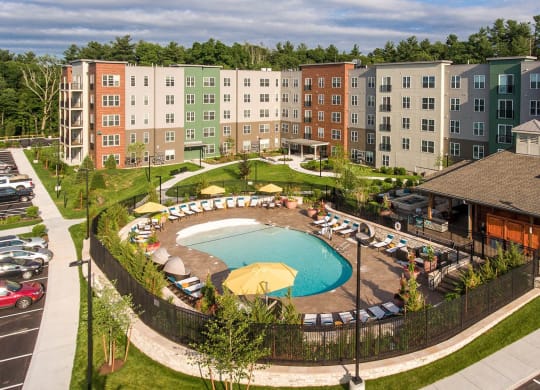 an aerial view of an apartment building and a swimming pool