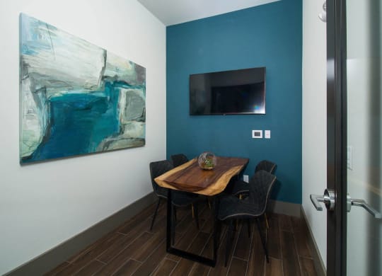 a dining room with a table and chairs and a television