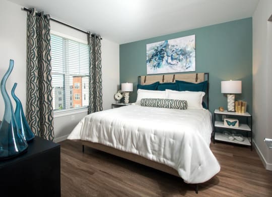 a bedroom with a bed and a large window
