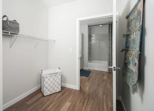 a room with a closet and a trash can in it