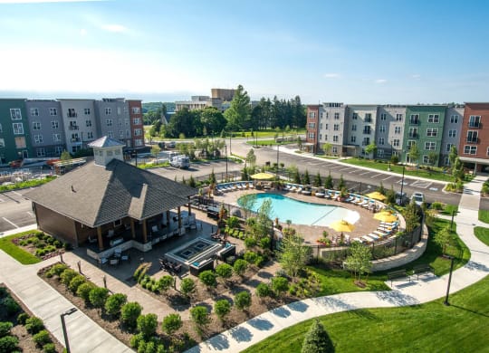 an aerial view of a swimming pool in front of a building