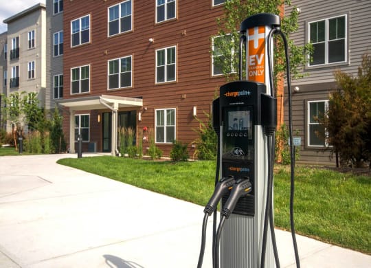 a gas pump in front of an apartment building
