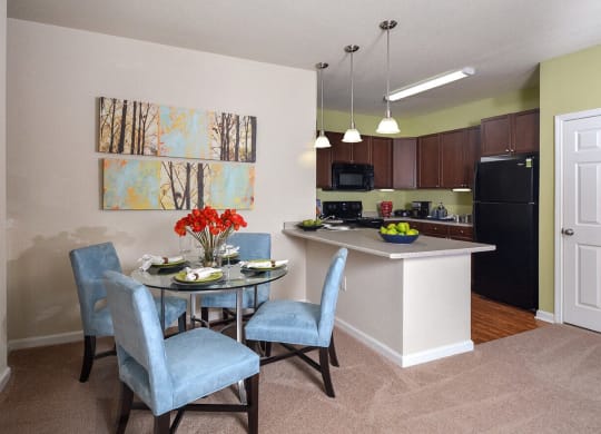 a dining room and kitchen with a table and chairs