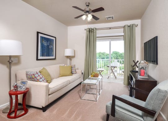 a living room with a couch and a ceiling fan