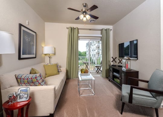 a living room with a couch and a ceiling fan