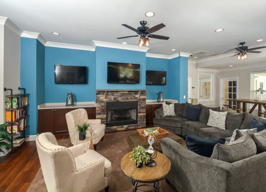 a living room with couches and chairs and a fireplace