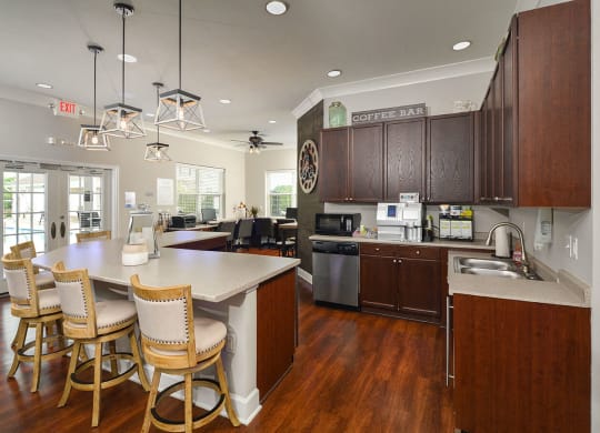 a kitchen with a center island and chairs