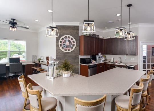 a kitchen with a large island and a clock on the wall