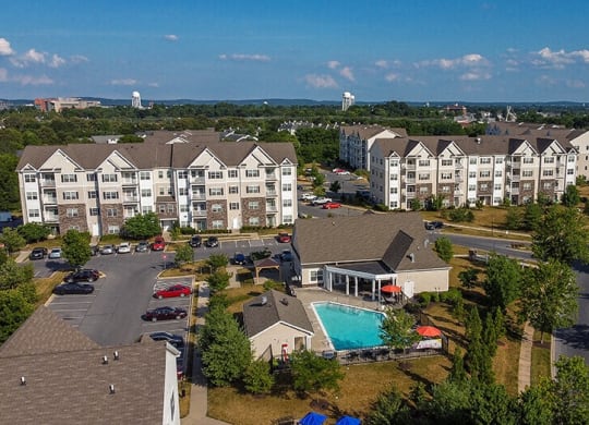 an aerial view of an apartment complex with a swimming pool