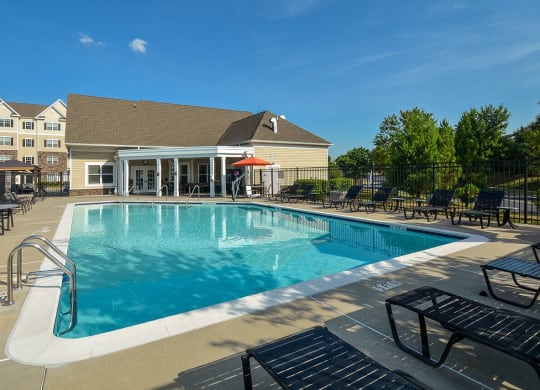 a swimming pool with a building in the background
