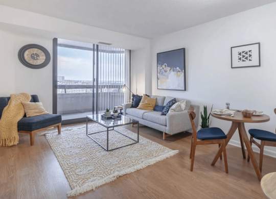 a living room with a couch and a table with chairs
