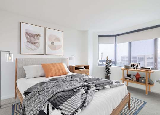 a bedroom with a bed and a large window