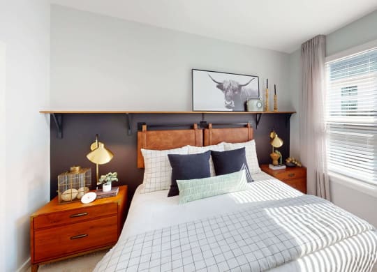 a bedroom with a bed and two windows