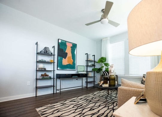 a living room with a couch and a ceiling fan